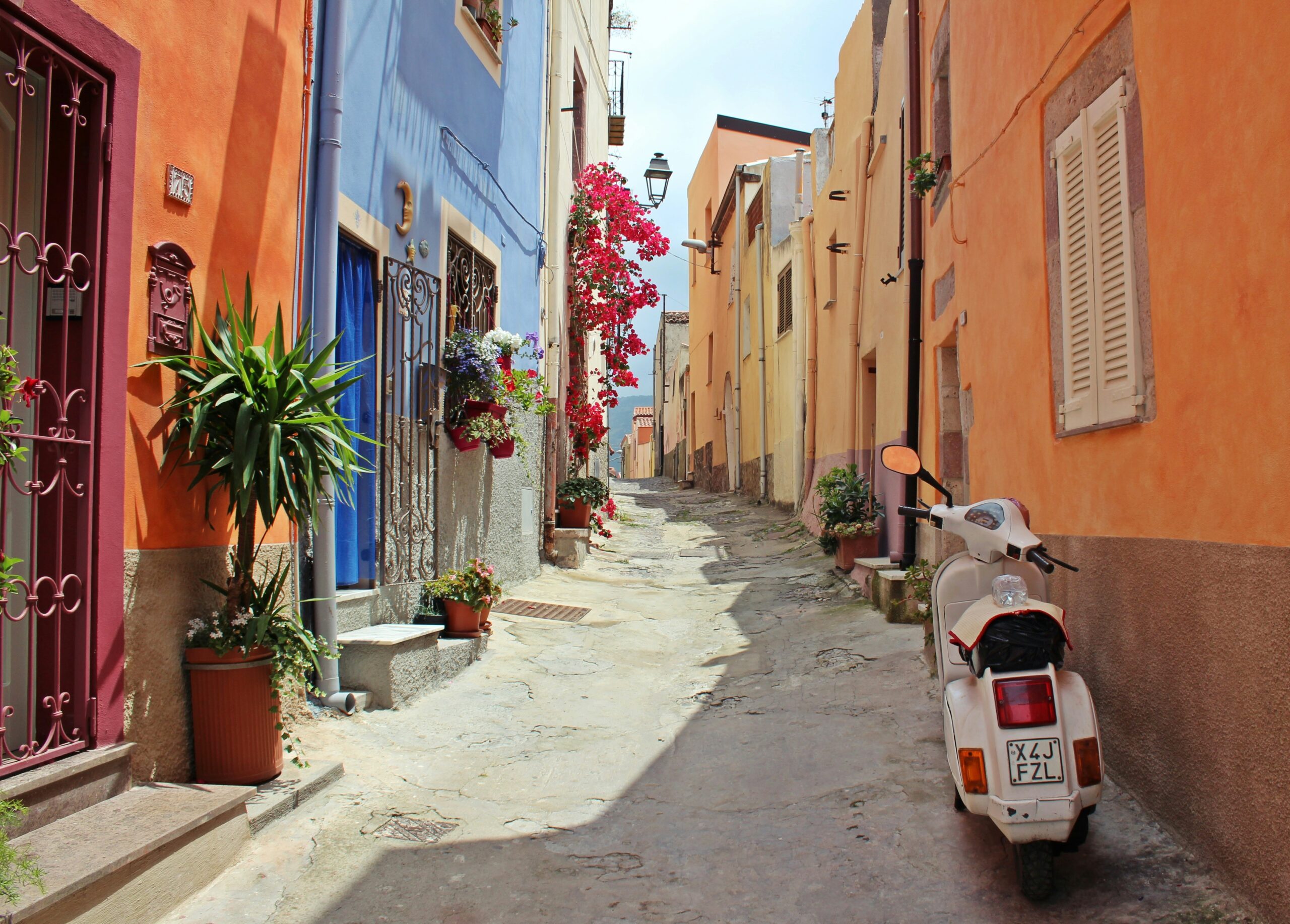 Narrow Italian town street with shops and everyday local life