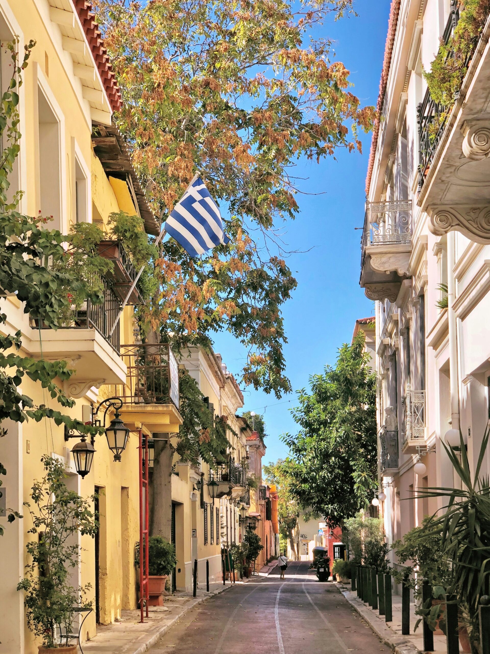 Greek street life in Athens with warm evening light and local buildings
