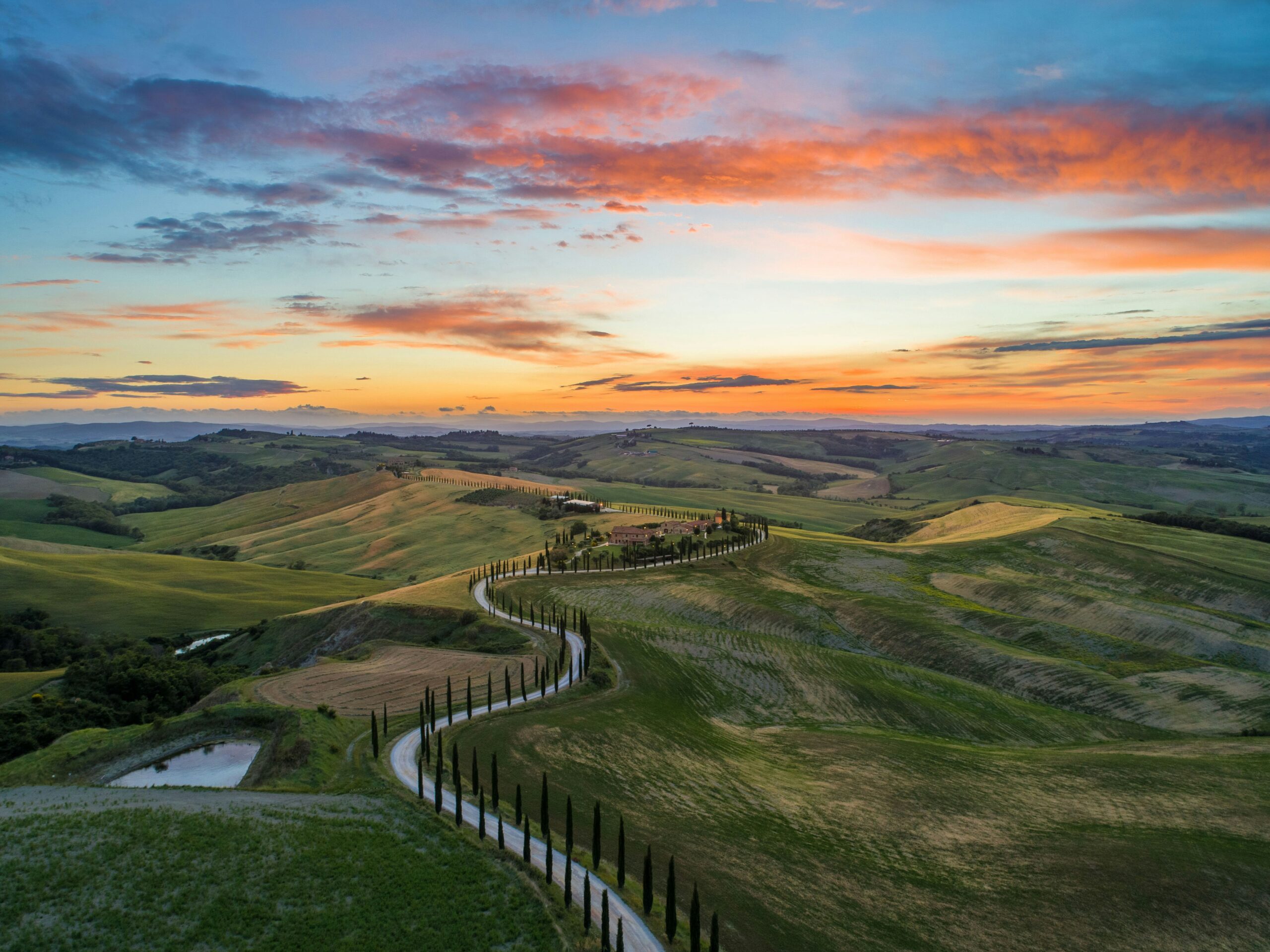Tuscan countryside with rolling hills and village landscape in Italy